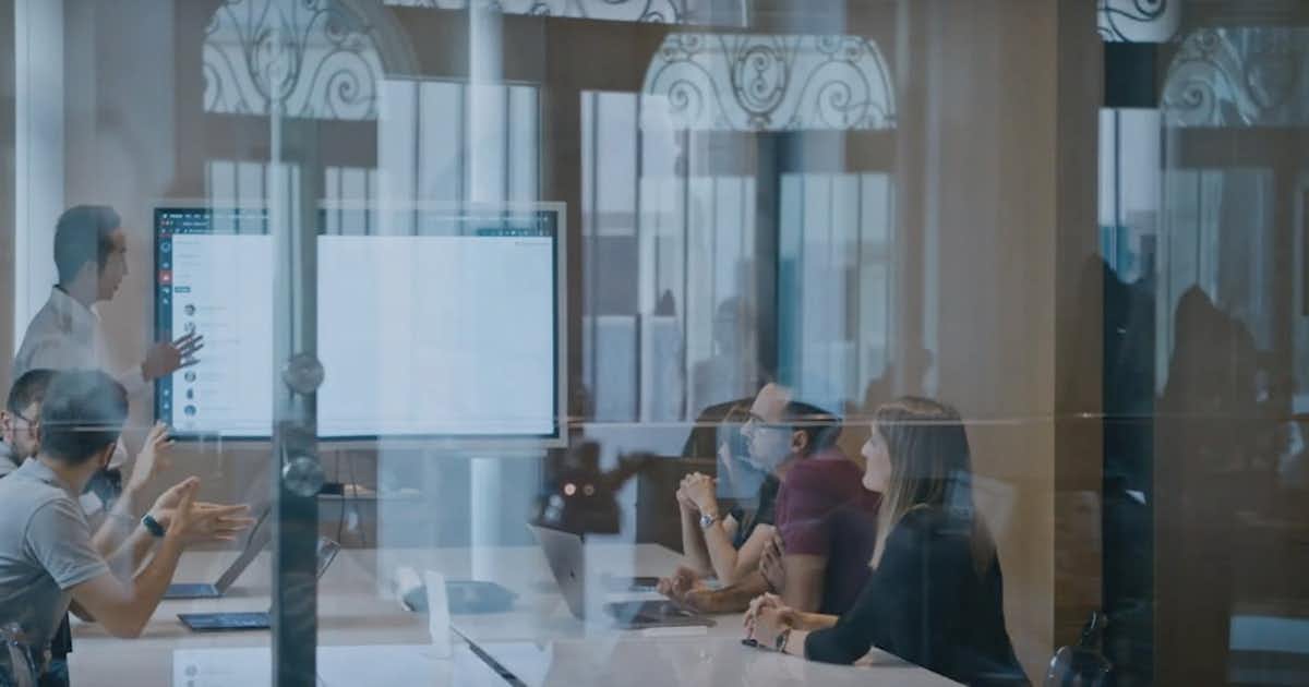 Woman presenting to others in a conference room