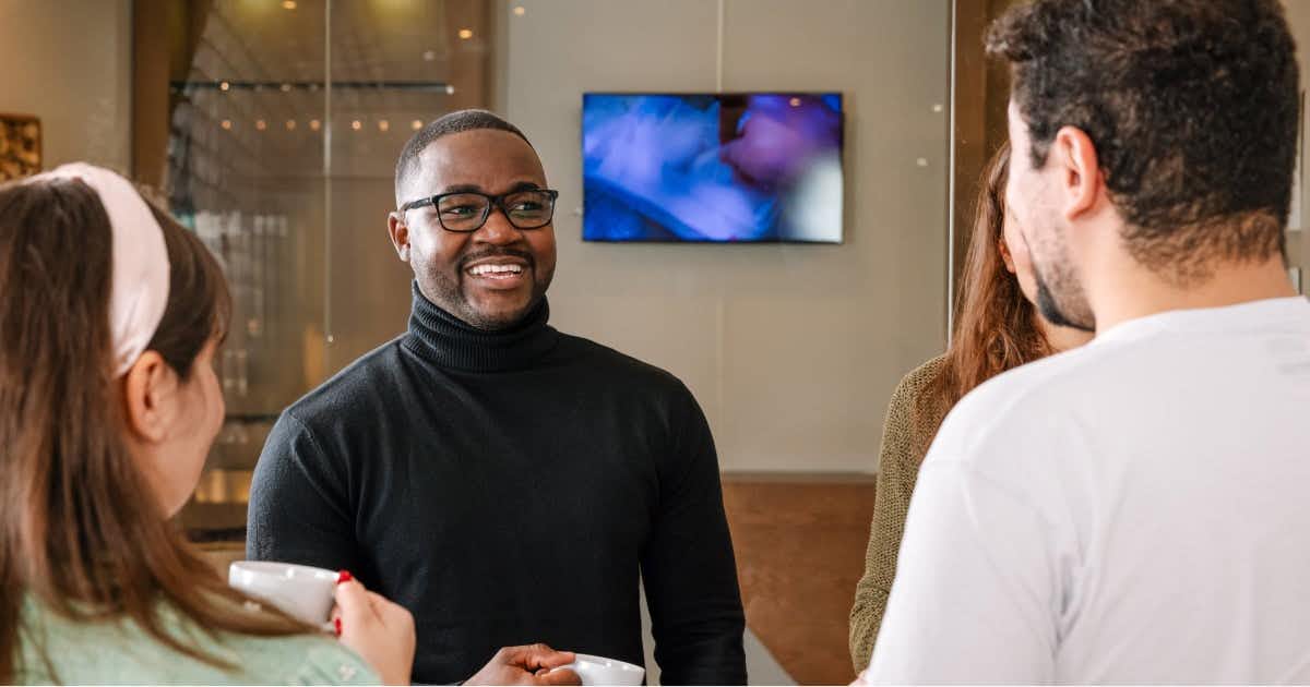 Man speaking with other employees