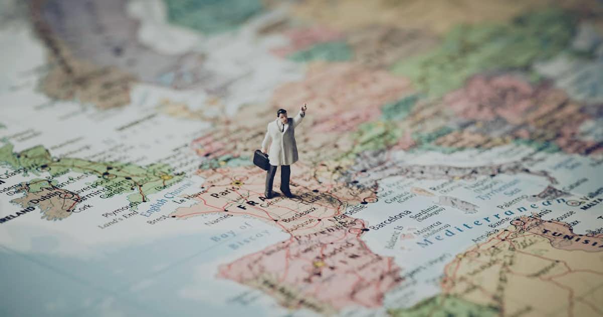 World map with a man standing on it