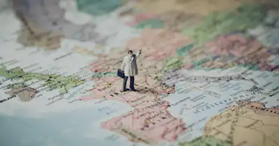 World map with a man standing on it