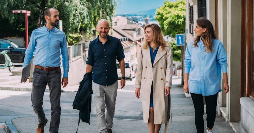 Group of male and female employees walking down the street