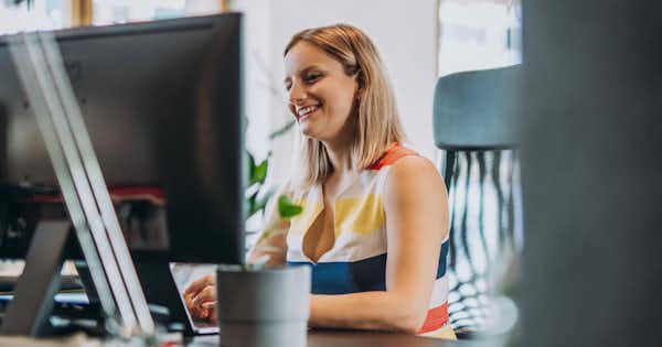 Smiling woman at a computer