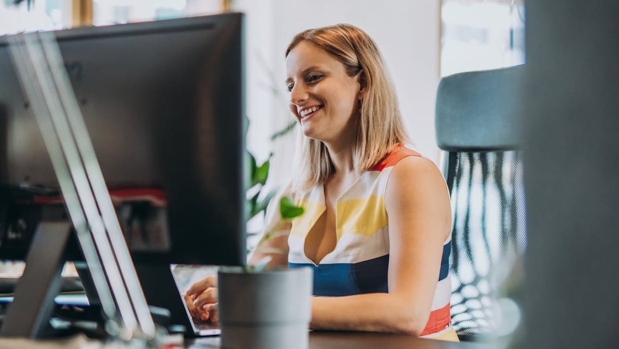 Smiling woman at a computer