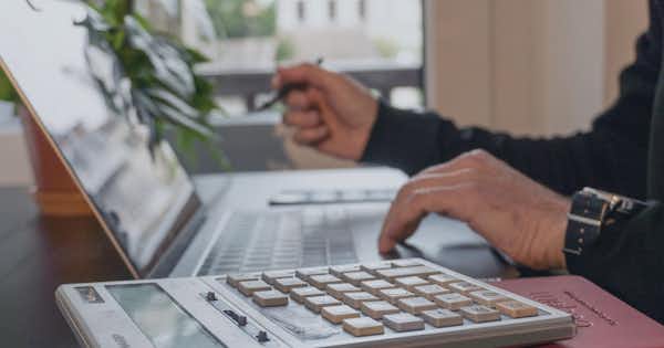 Hands typing on a laptop computer