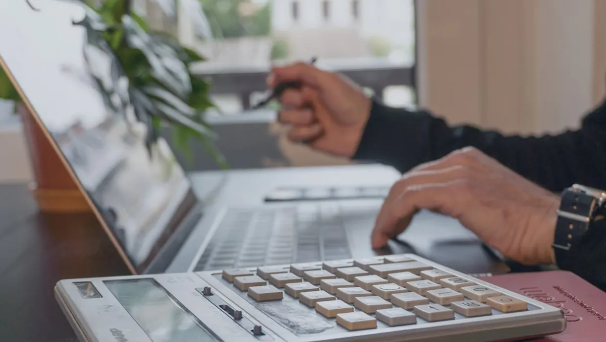 Hands typing on a laptop computer