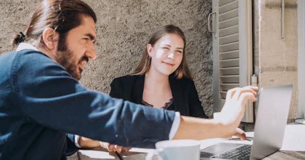 Man and woman at desk with computer