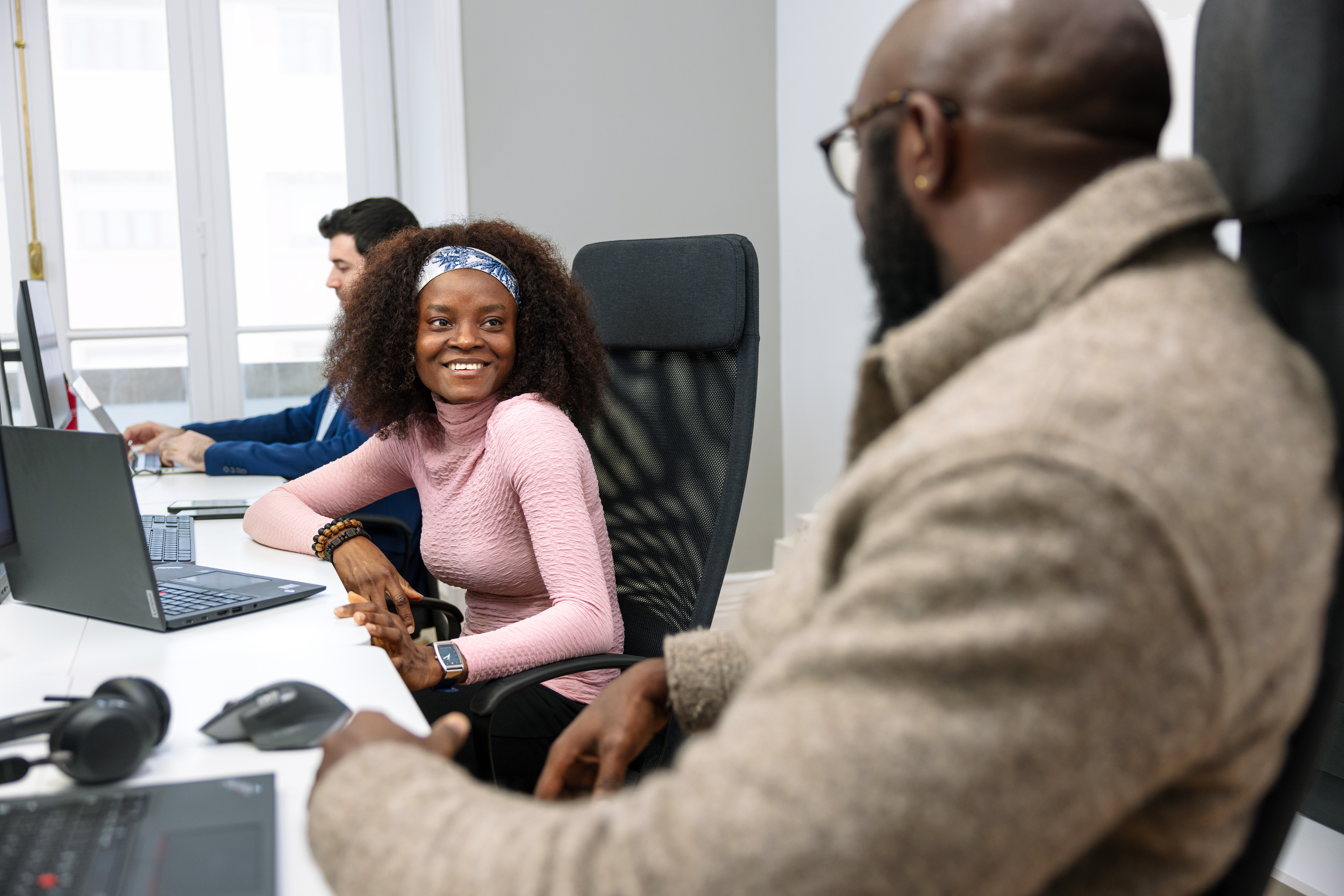 Two people at their desk in the office. 