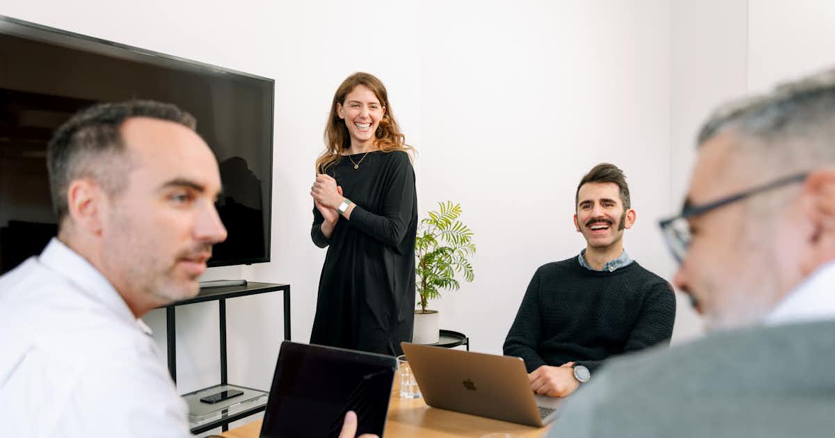 four people in an office setting