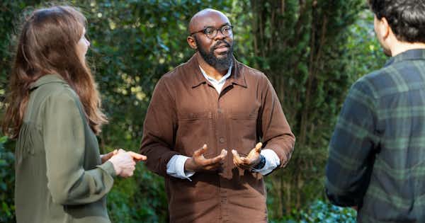group of three individuals having a casual conversation
