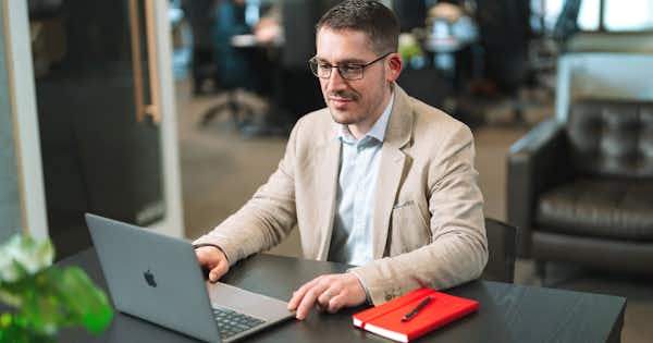 A person in front of the laptop.