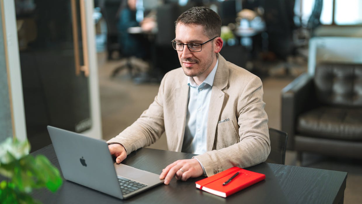A man sitting at a desk, working on a la