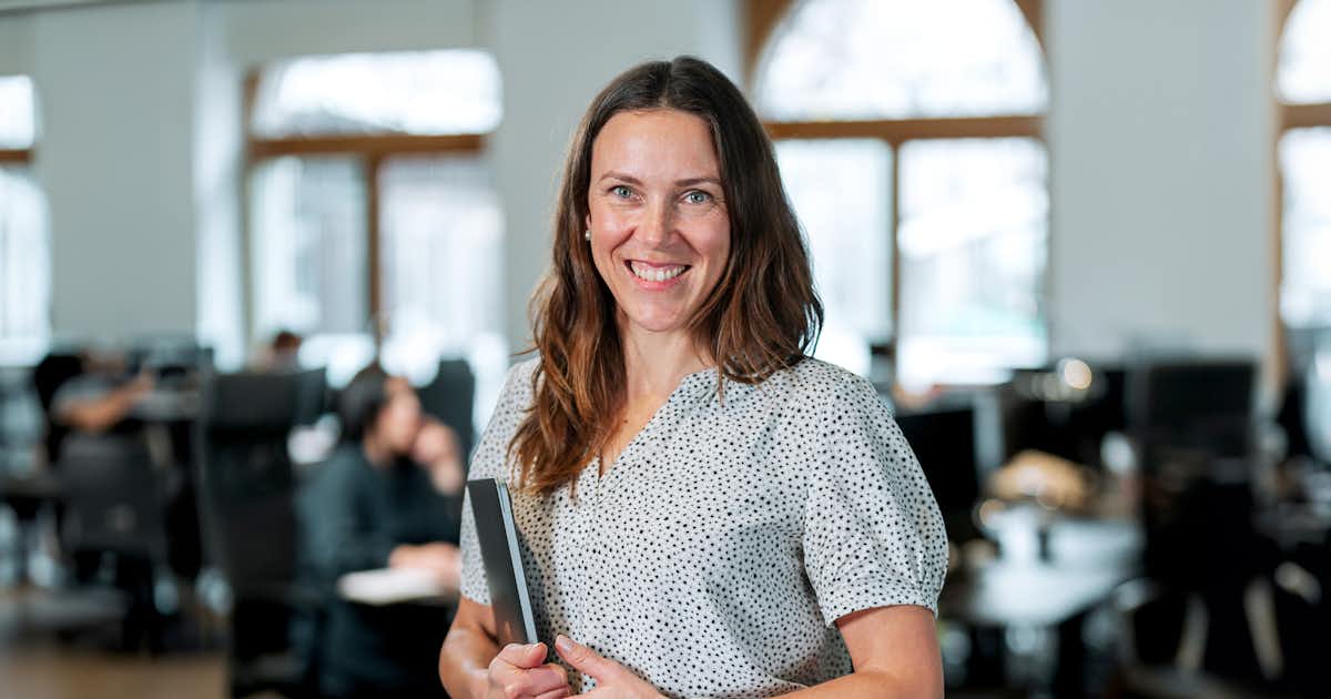 A photo of a woman in a bright office.