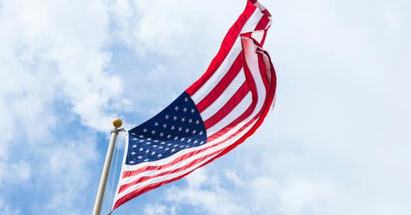 The US flag with the sky in the background.