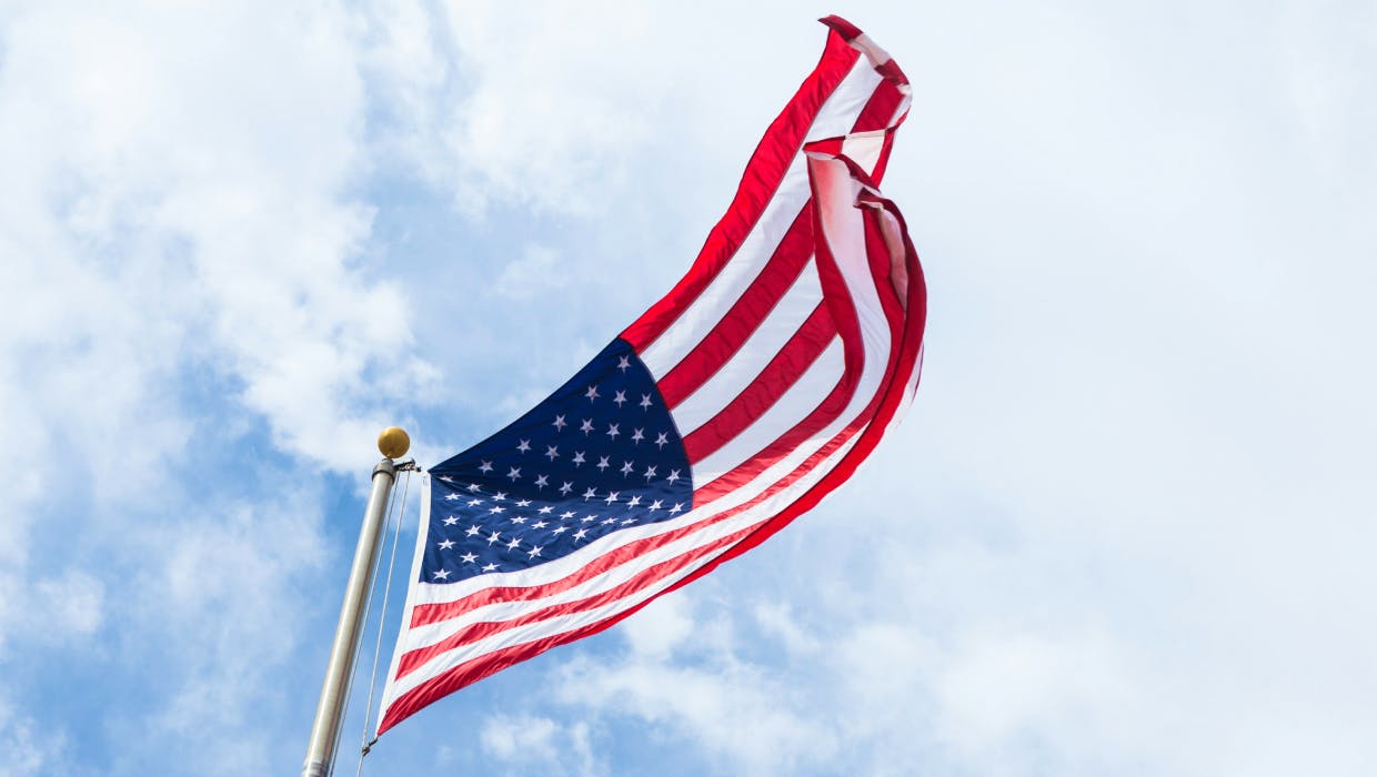 The US flag with the sky in the background.