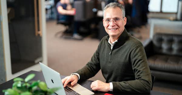 Happy employee sitting at his desk