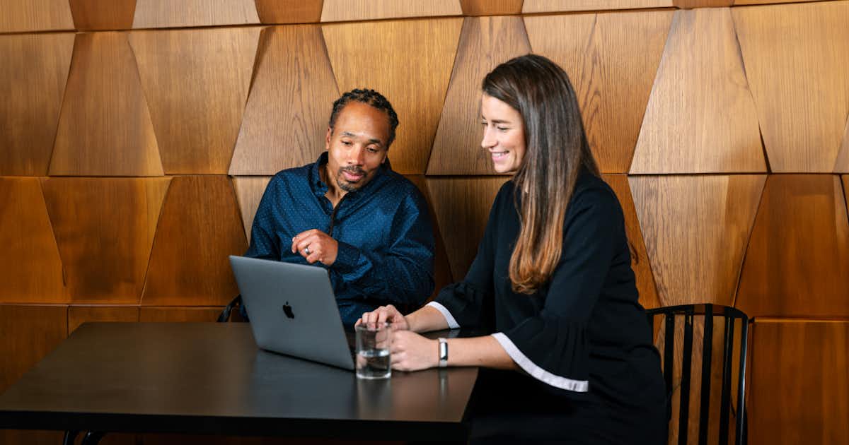 Two employees looking at a computer screen together