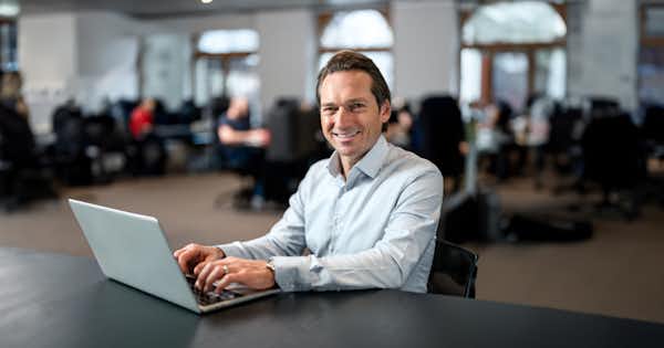 Man at desk with laptop.