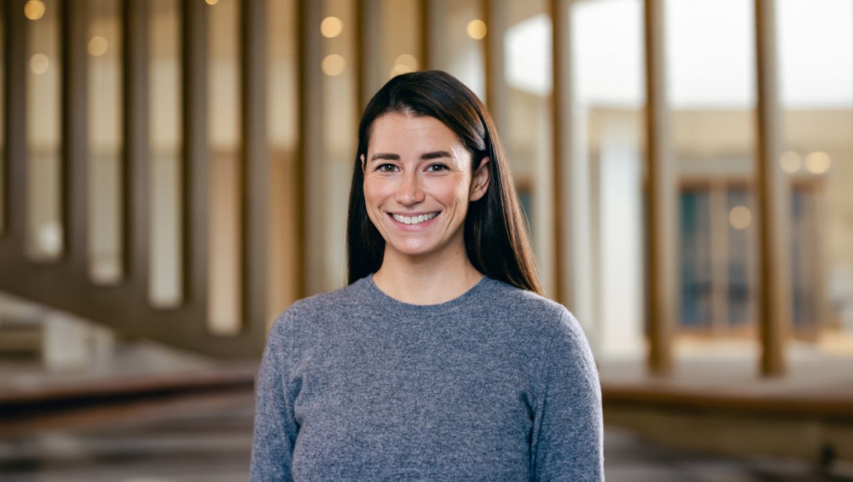 Woman standing in office, smiling