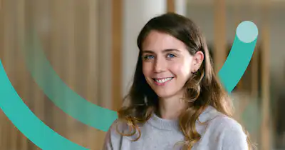 Woman smiling and a half circle graphic device behind her.