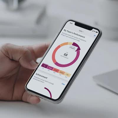 Someone holding smart phone displaying a graph and numbers