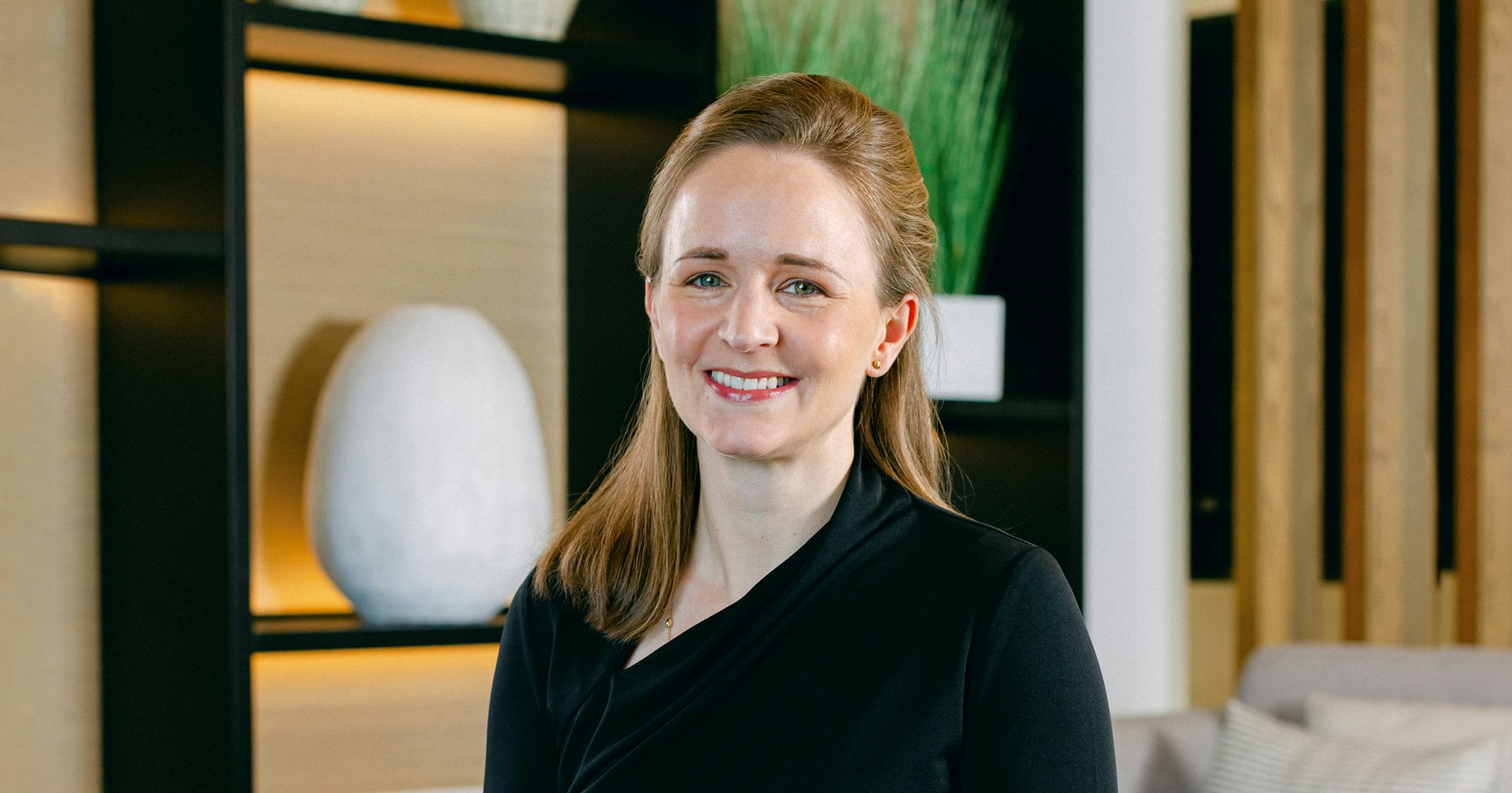 A portrait of a woman in an office setting.