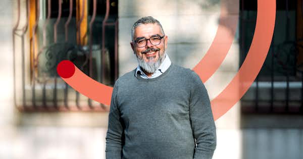picture of an employee smiling in front of an office building