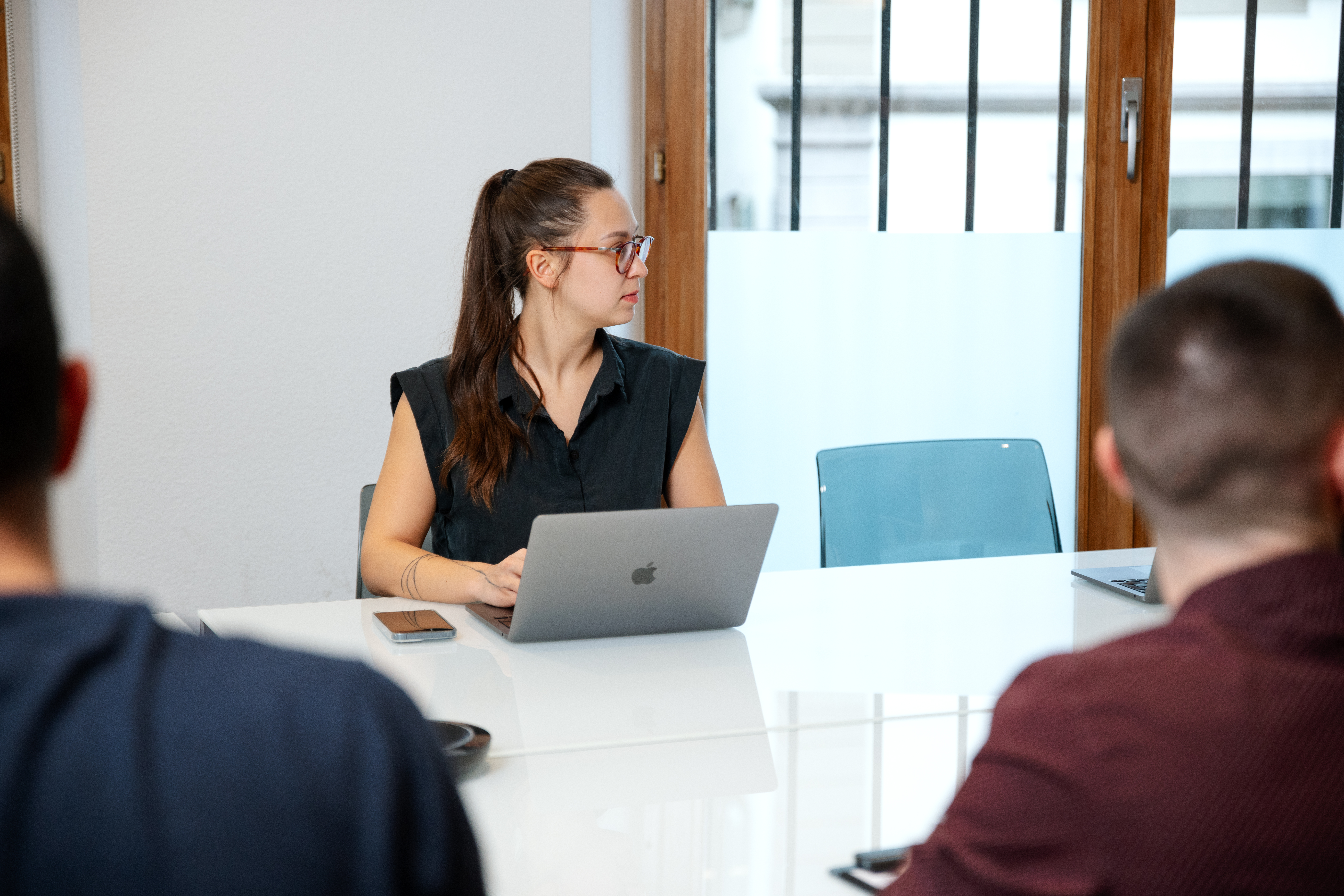Woman in a meeting room with a computer.