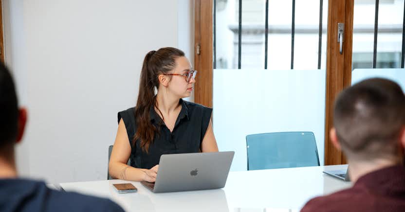 Woman in a meeting room with a computer.