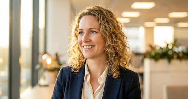 Woman in a work setting smiling.