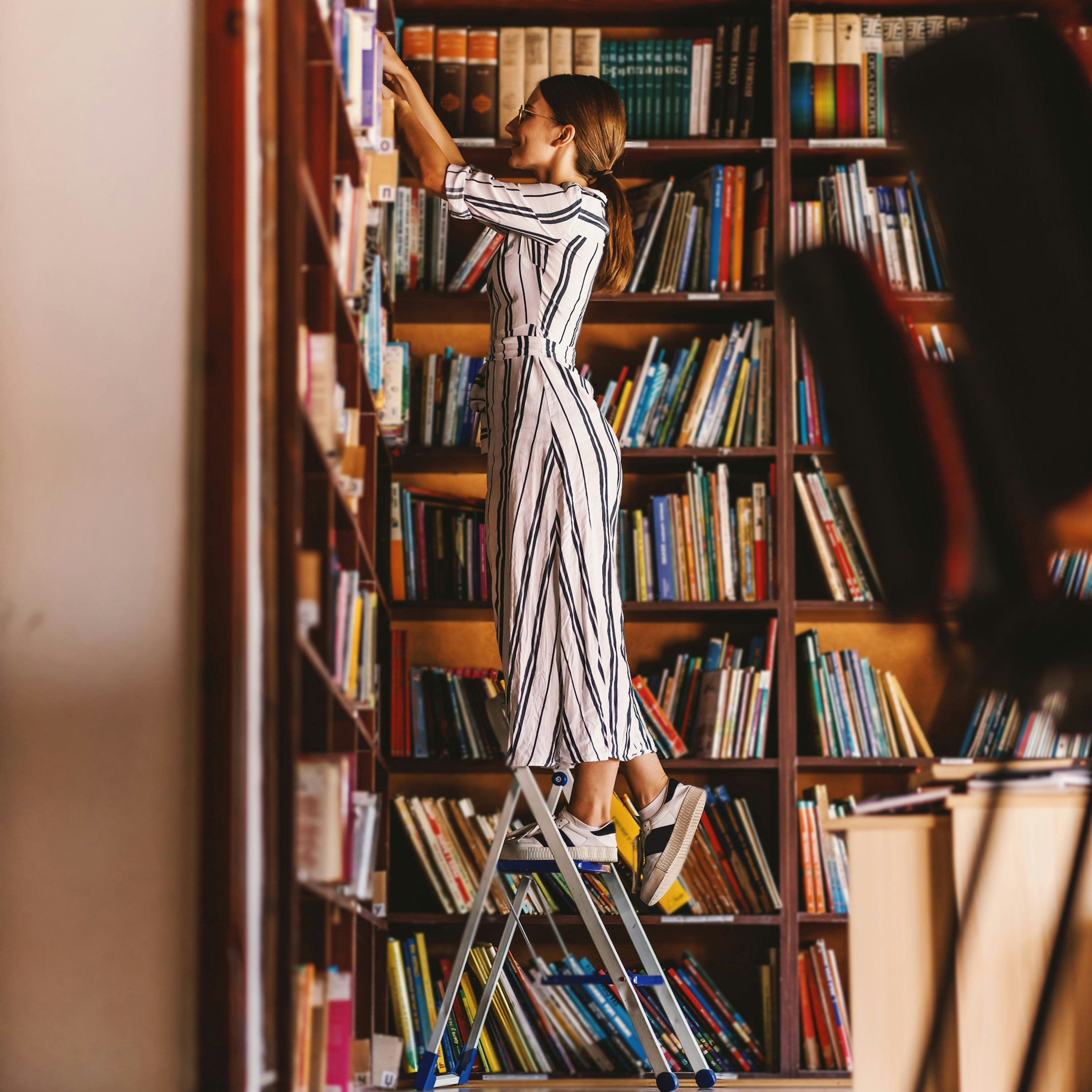 Person grabbing books