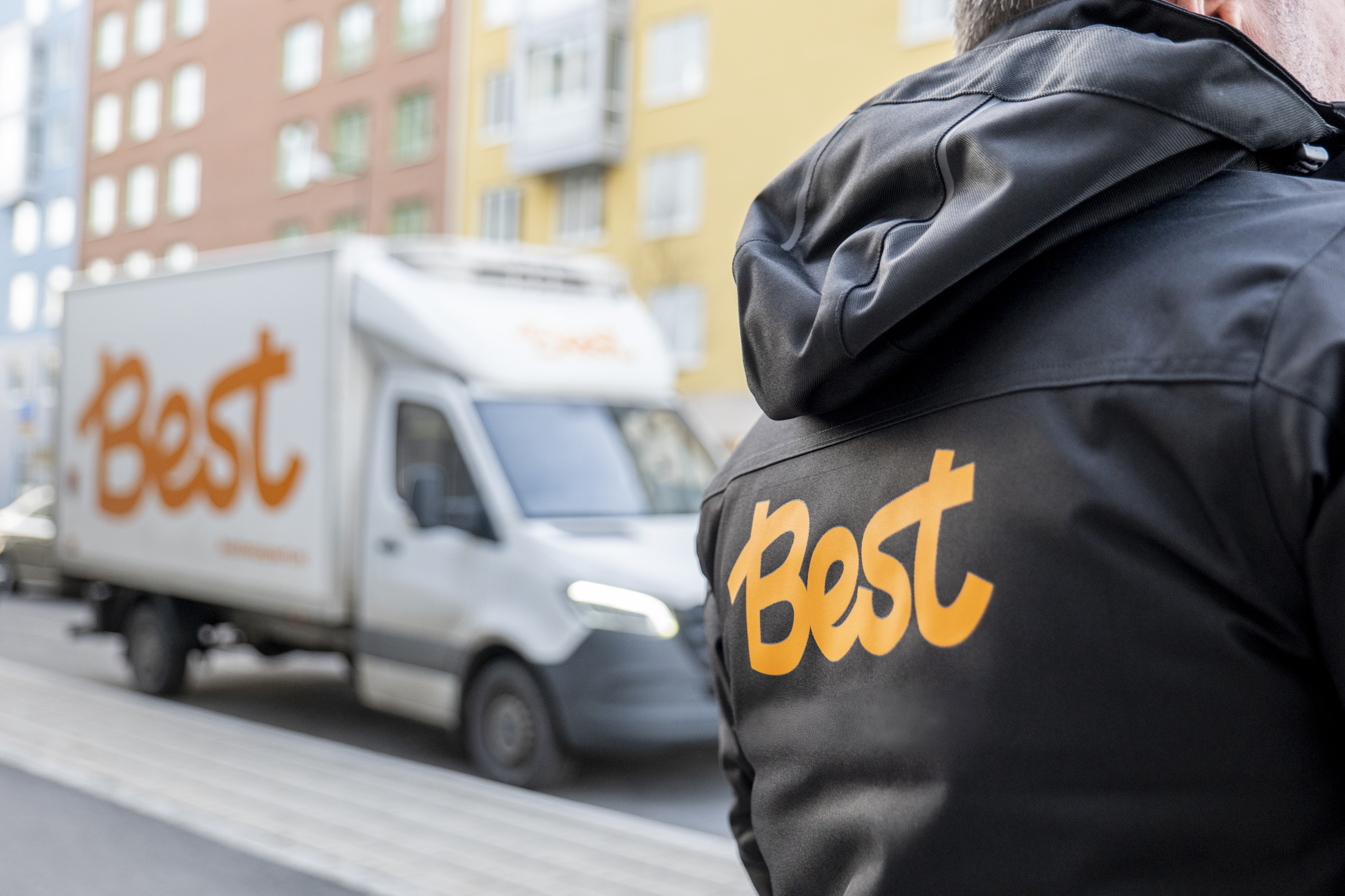 Best lastbil och chaufför med logo på ryggen