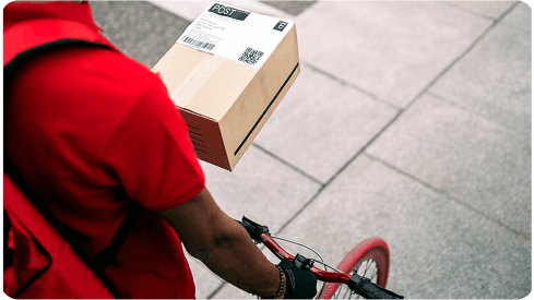 Bike messenger on the street delivering a package.