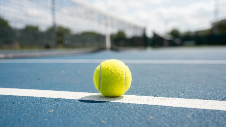 Yellow tennis ball on court