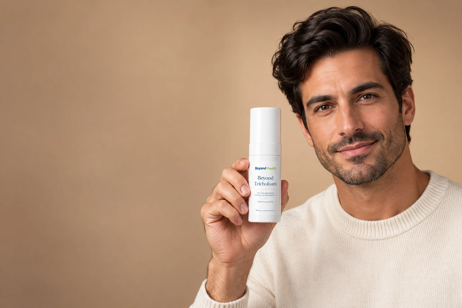 Man holding a bottle of Beyond Trichofoam hair-care foam