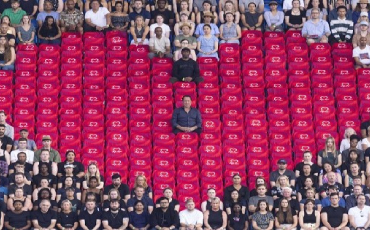 David Seaman sitting in a heart shape made by 180 vacant seats at a Premier League club stadium to represent lives lost to coronary heart disease each day in the UK 