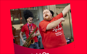 Front cover of the fundraising pack, showing an image of a person dancing and a person playing the saxophone