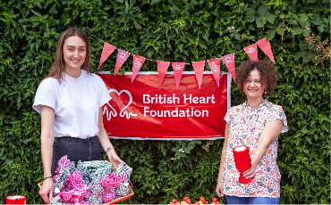 Two people fundraising at a British Heart Foundation stall