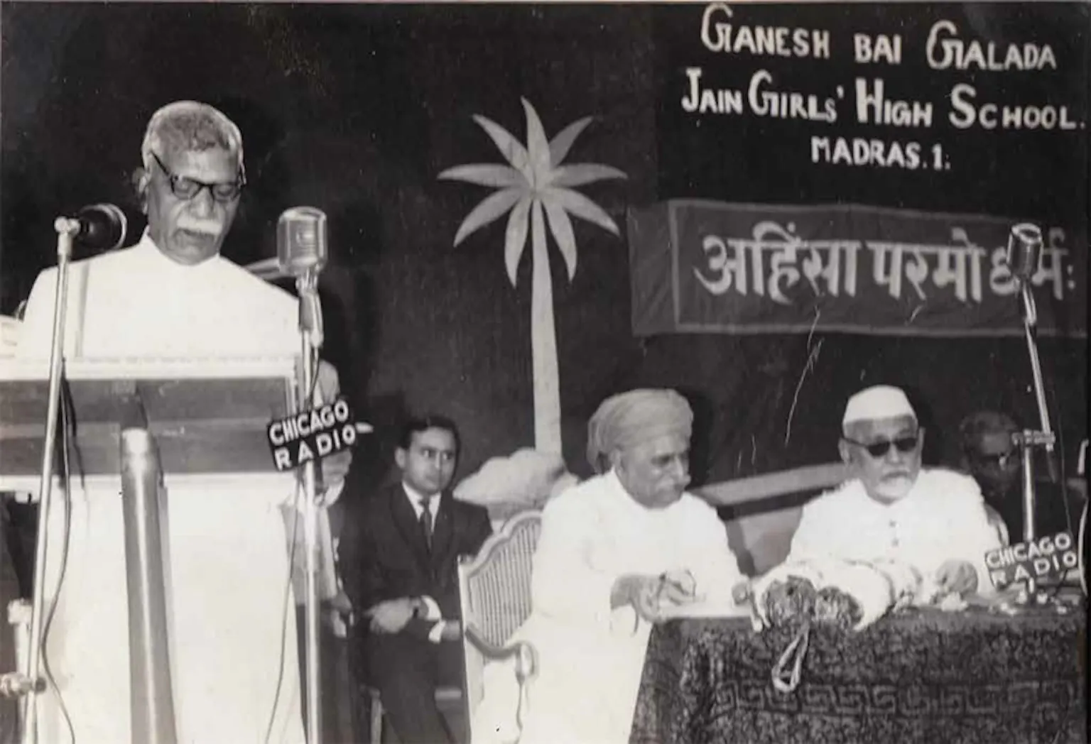 Delivering a speech with Dr. Zakir Hussain (third President of India) in the background