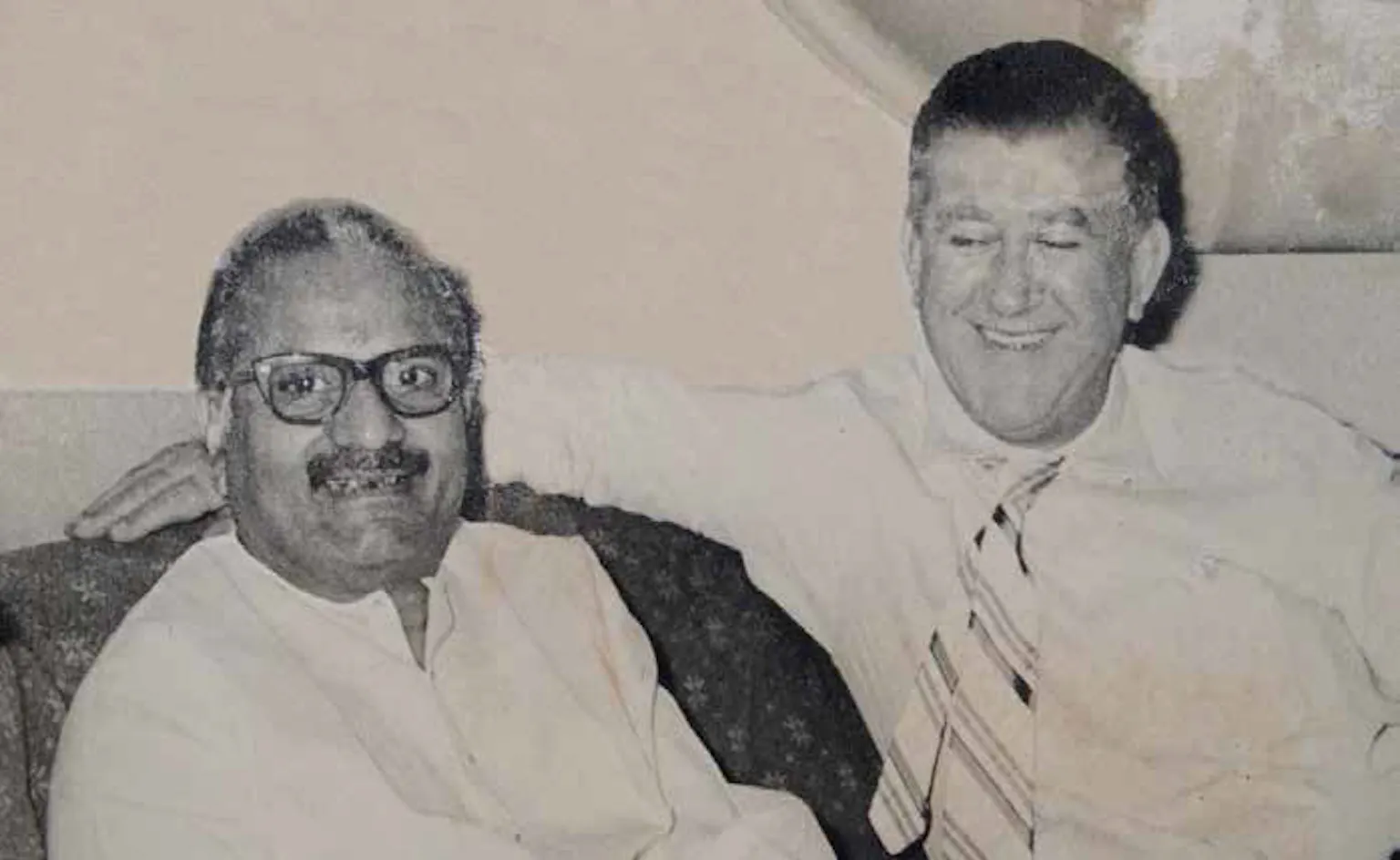 In a jovial mood with business associate R.E. Sutton