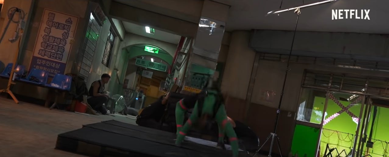 Troy James in a green suit performing stunts