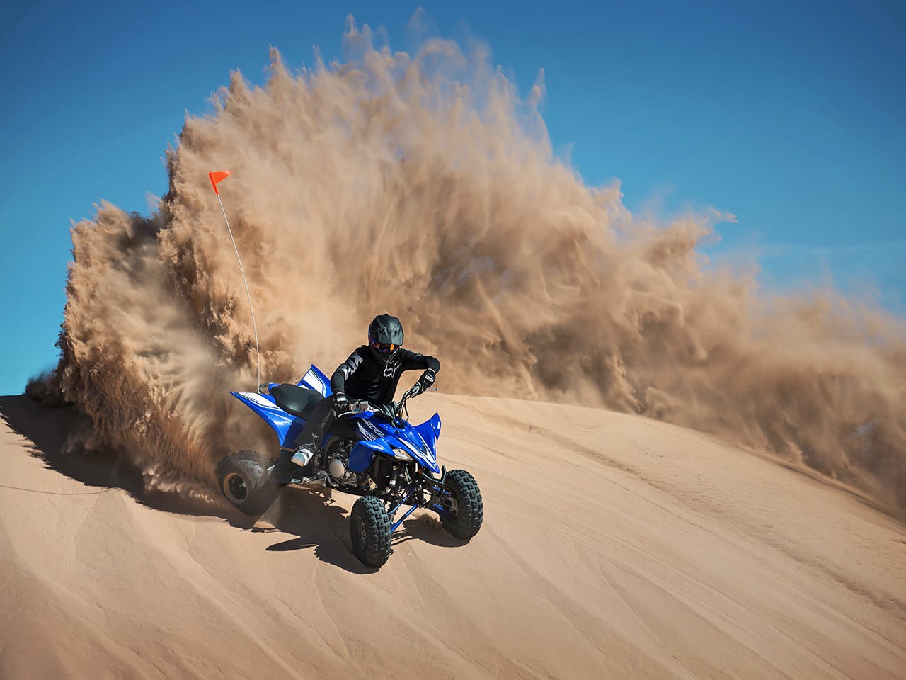 Yamaha YFZ450R in team yamaha blue colour , being ridden in the desert