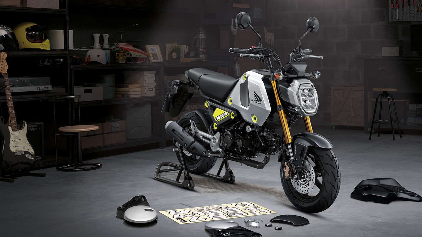 Honda GROM in force silver metallic colour, parked