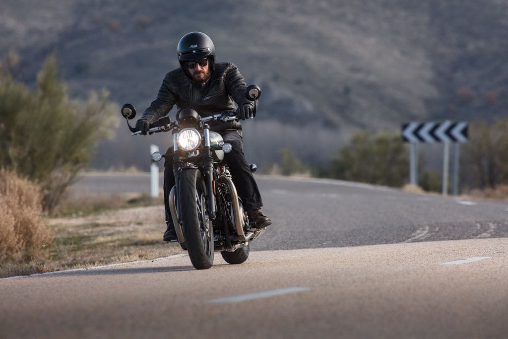 TRIUMPH BONNEVILLE BOBBER being ridden on the hill road