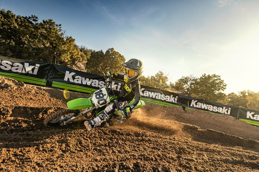 KAWASAKI KX65 in lime green colour on off-road track