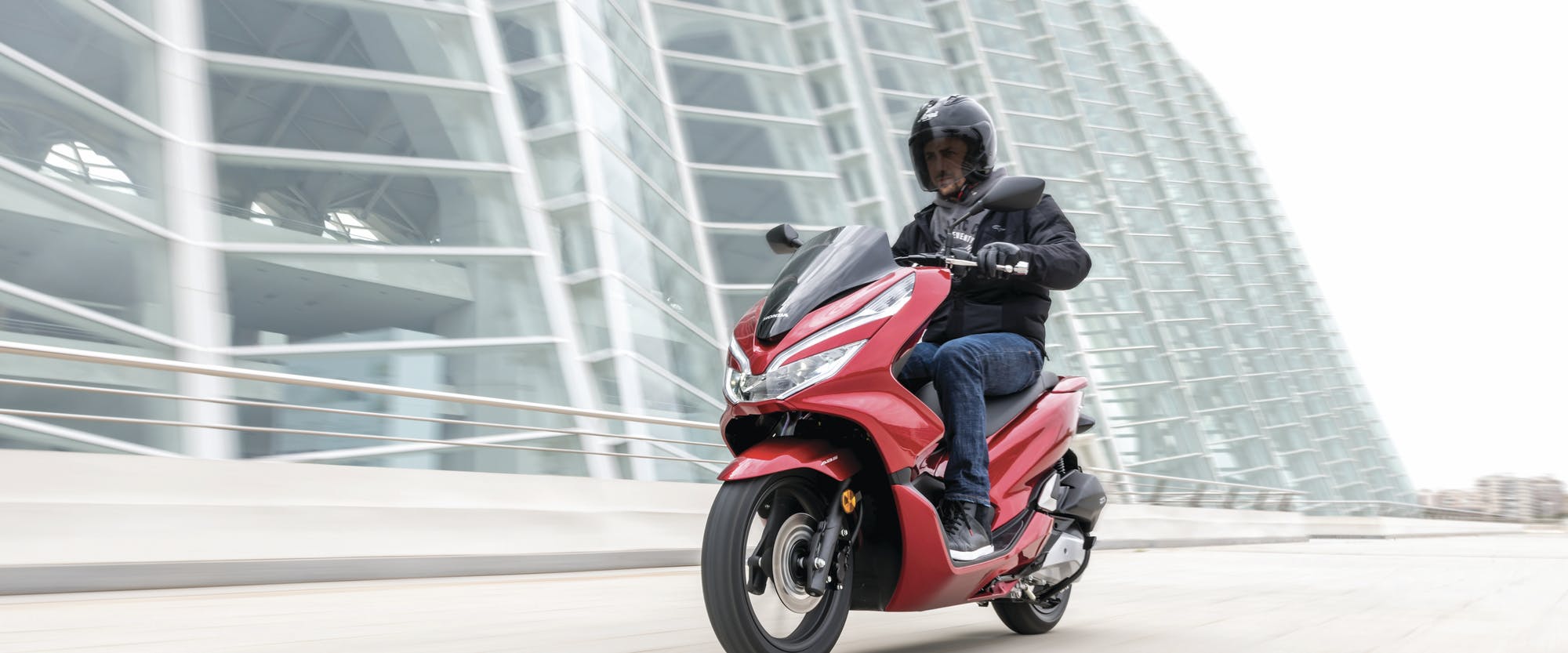 Honda PCX150 in candy lustre red colour on the road