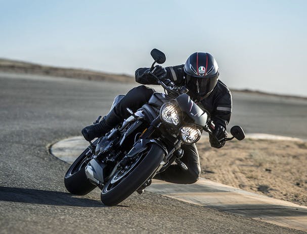 TRIUMPH SPEED TRIPLE S being ridden on the hill road