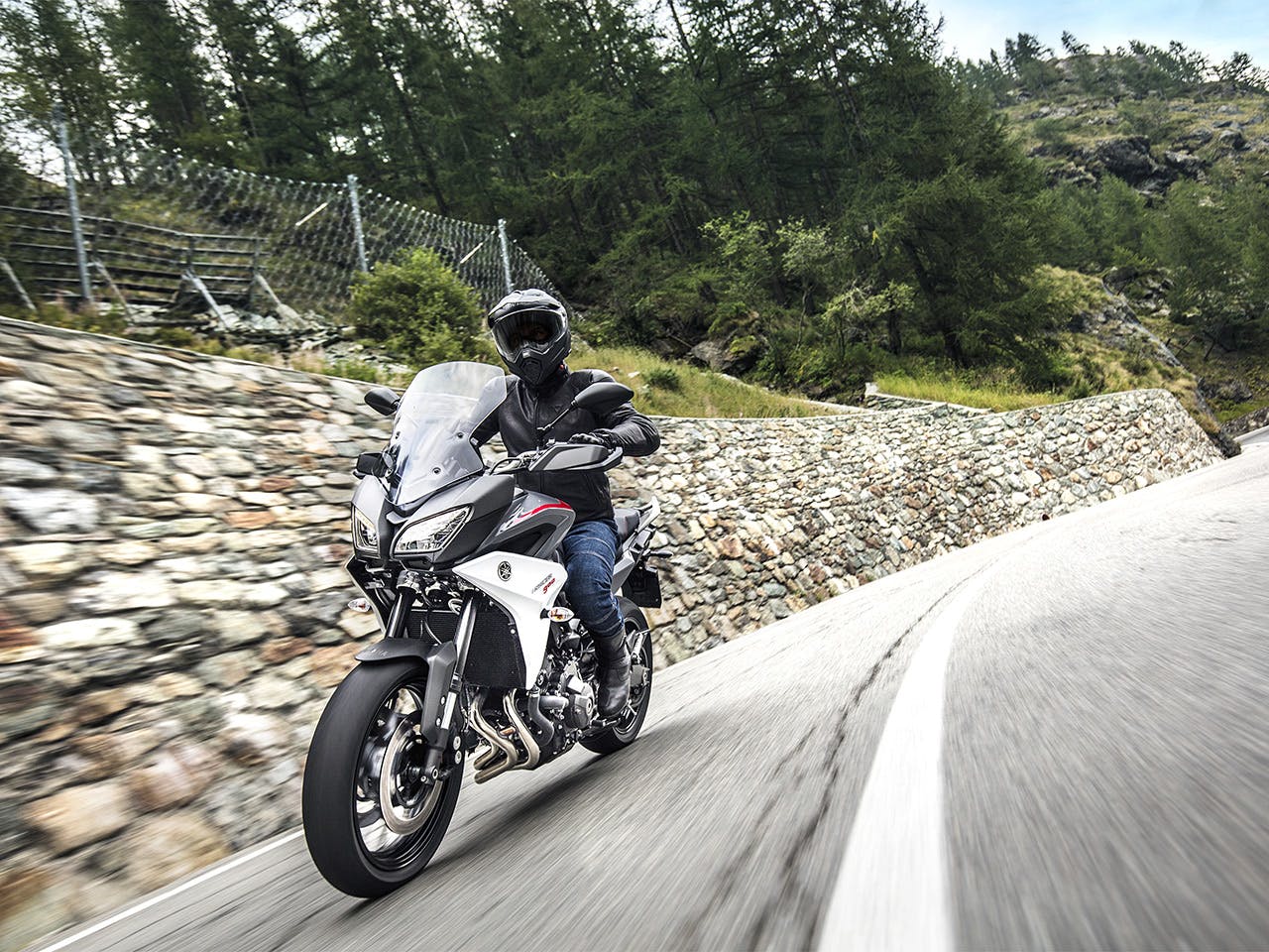 Yamaha Tracer 900 motorcycle riding on the hill road