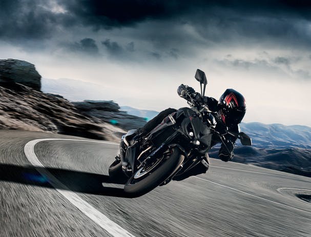 KAWASAKI Z1000 in metallic flat spark black and metallic matte graphite gray colour being ridden on a hill road