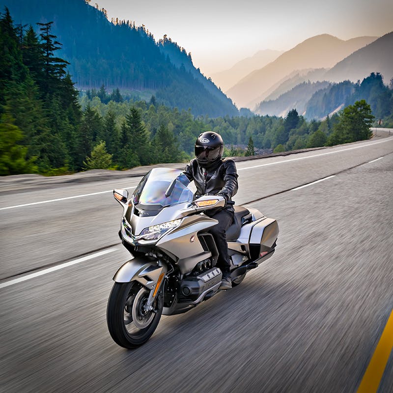 Honda 2018 Goldwing in matte majestic silver metallic colour, being ridden on the hill road