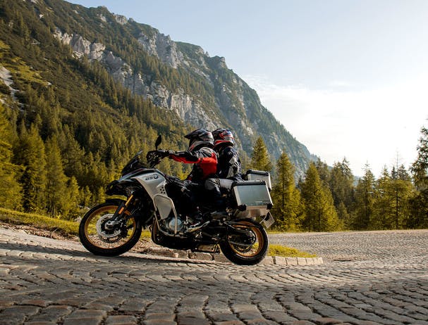 BMW F 850 GS ADVENTURE RALLYE being ridden on a hill road with a passenger